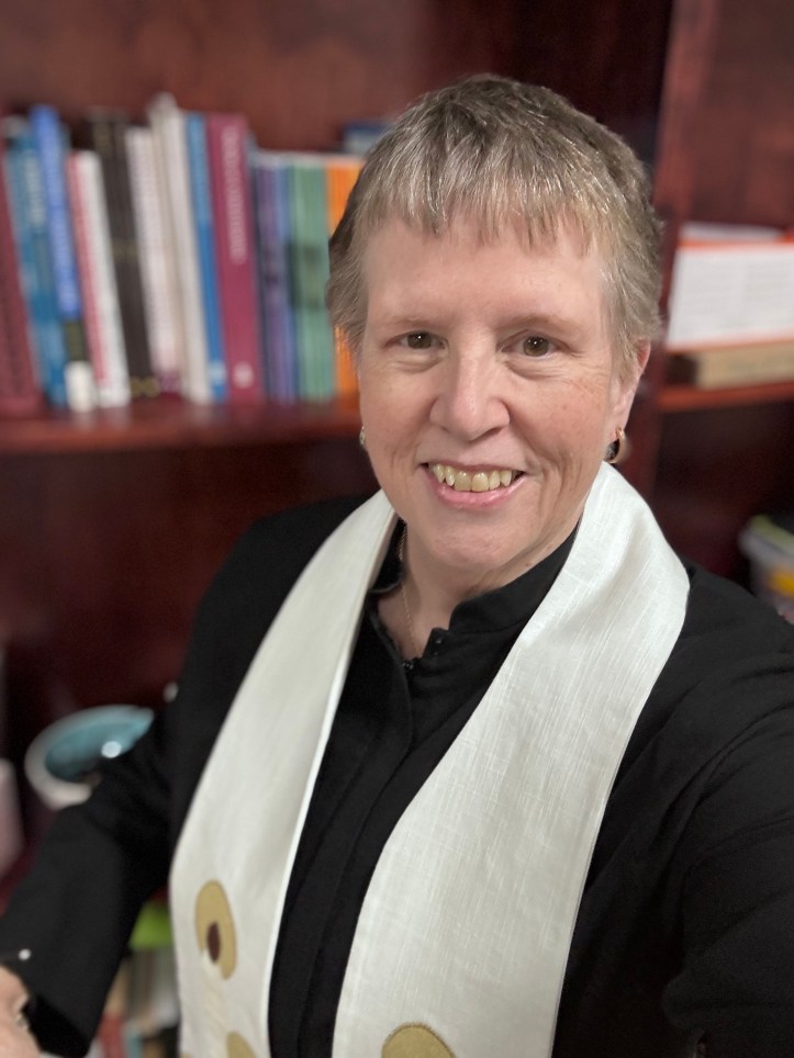 Pastor in black robe and Christmas stole
